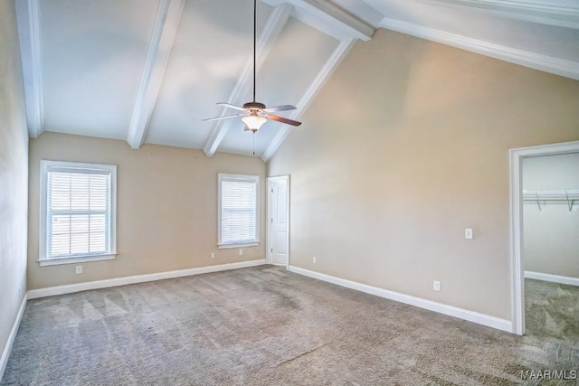 carpeted spare room with high vaulted ceiling, plenty of natural light, beam ceiling, and ceiling fan