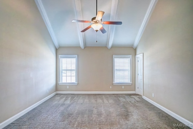 carpeted spare room featuring vaulted ceiling with beams, ceiling fan, and ornamental molding