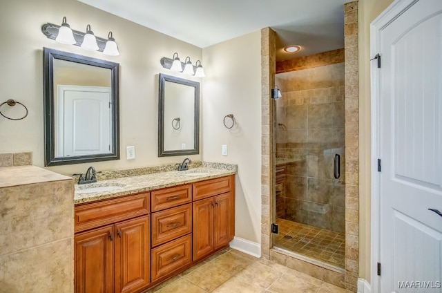 bathroom featuring tile patterned flooring, vanity, and an enclosed shower