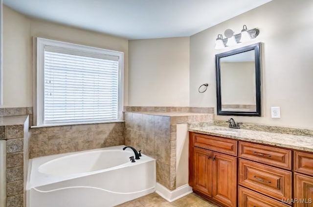 bathroom featuring tile patterned flooring, vanity, and a washtub