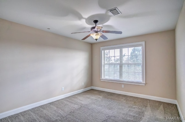 unfurnished room with carpet flooring and ceiling fan