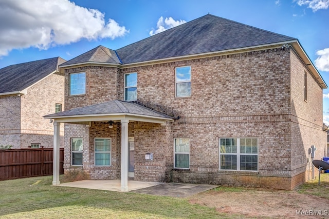 rear view of house with a patio area and a lawn