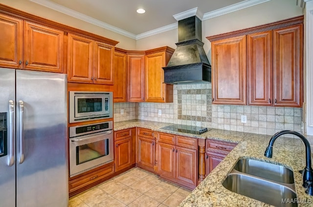 kitchen featuring light stone countertops, ornamental molding, custom exhaust hood, stainless steel appliances, and sink