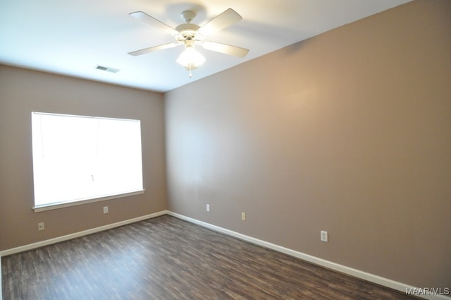 empty room with ceiling fan and dark wood-type flooring