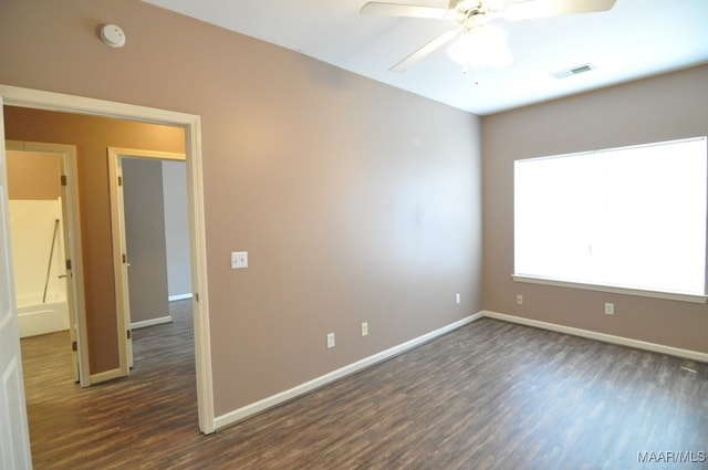 empty room featuring dark hardwood / wood-style floors and ceiling fan