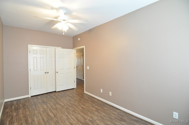 unfurnished bedroom featuring ceiling fan, a closet, and dark hardwood / wood-style floors