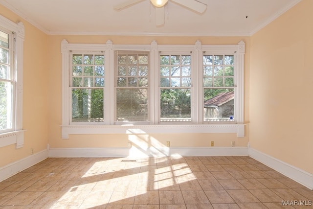 tiled empty room featuring plenty of natural light, ceiling fan, and crown molding