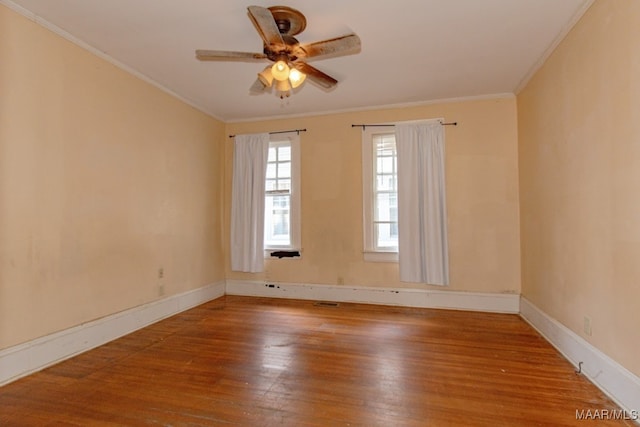 empty room with wood-type flooring, ceiling fan, and crown molding