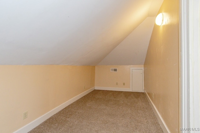 bonus room with carpet flooring and lofted ceiling