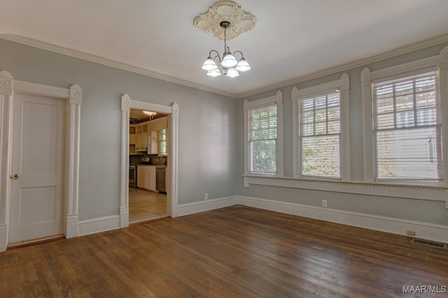 unfurnished dining area with crown molding, dark hardwood / wood-style flooring, and a chandelier