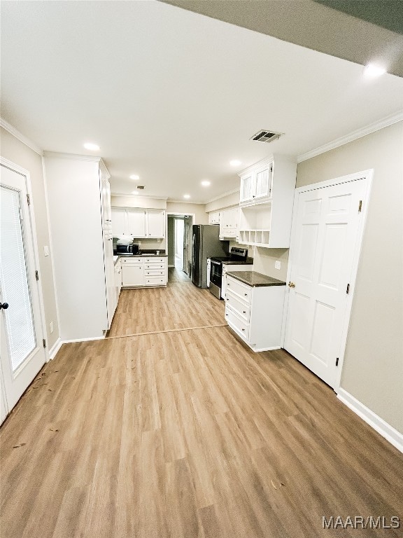 kitchen featuring stainless steel appliances, white cabinetry, light hardwood / wood-style floors, and crown molding