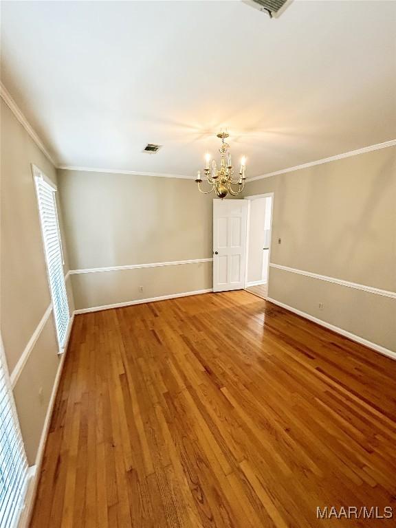 103 Wilkins Rd, Selma, AL 36701 - unfurnished room featuring a chandelier, wood finished floors, and crown molding