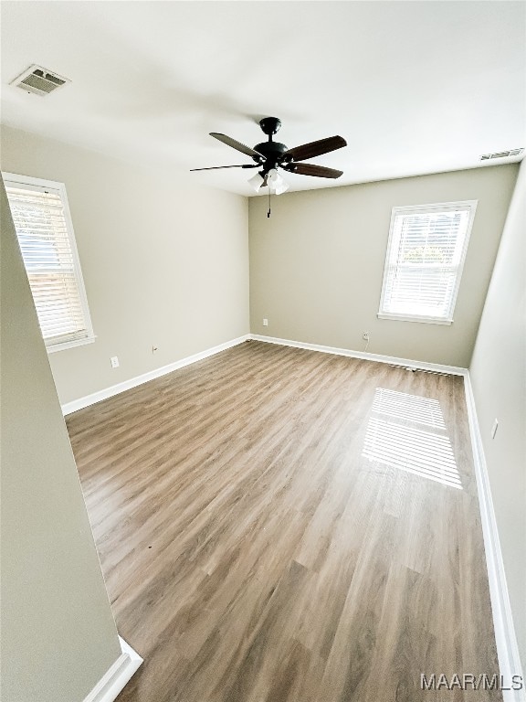 unfurnished room featuring ceiling fan and wood-type flooring