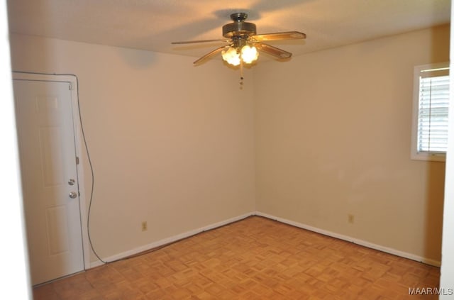 spare room with light parquet flooring and ceiling fan