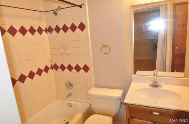 full bathroom with toilet, vanity, and tiled shower / bath