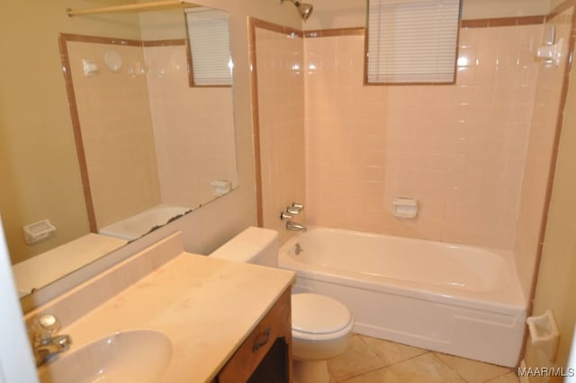 full bathroom featuring tile patterned flooring, vanity, toilet, and tiled shower / bath