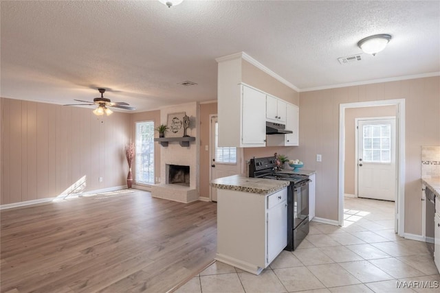 kitchen with white cabinets, plenty of natural light, light hardwood / wood-style floors, and black range with electric cooktop