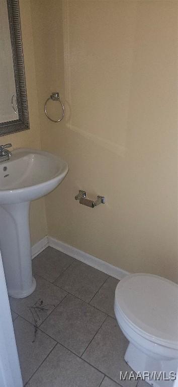 bathroom with sink, tile patterned flooring, and toilet