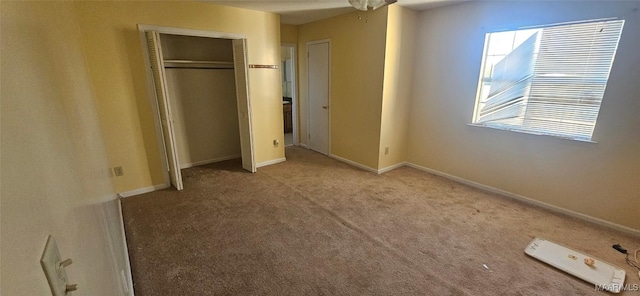 unfurnished bedroom with carpet floors and a closet