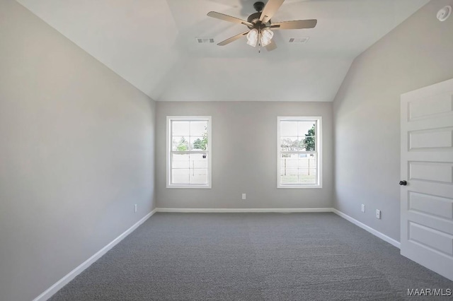 empty room with baseboards, dark carpet, a ceiling fan, and lofted ceiling