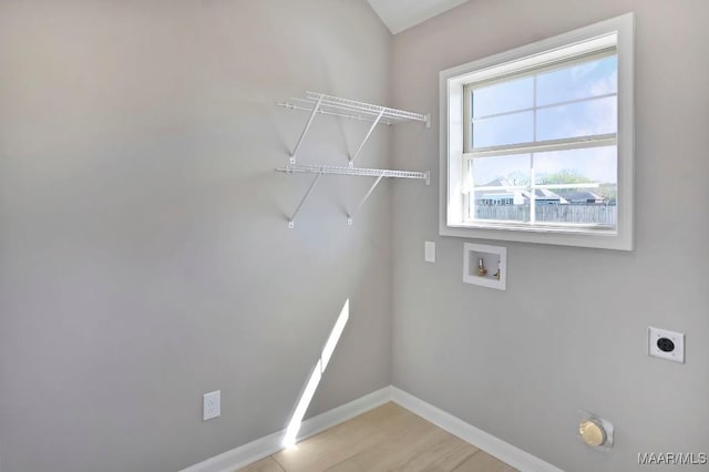 clothes washing area with hookup for a washing machine, hookup for an electric dryer, laundry area, and baseboards