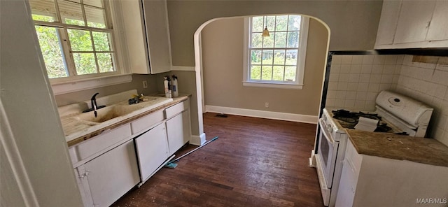 kitchen featuring white cabinets, sink, tile walls, dark hardwood / wood-style flooring, and white range with gas stovetop