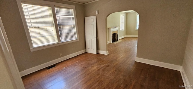 unfurnished room with hardwood / wood-style flooring and a healthy amount of sunlight