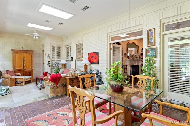 sunroom / solarium featuring a skylight and ceiling fan