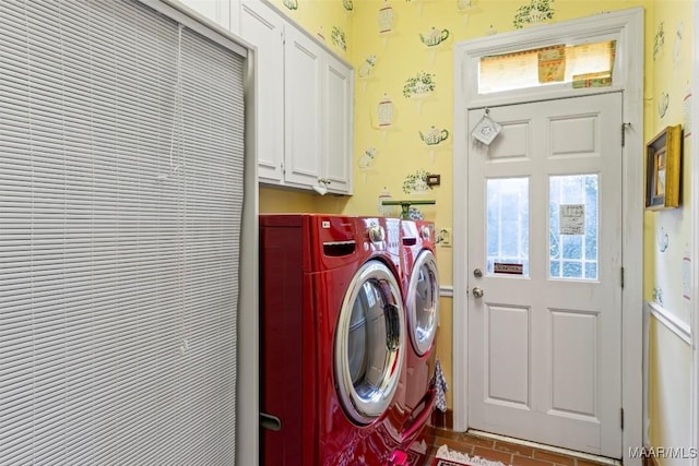 washroom featuring washing machine and dryer and cabinets