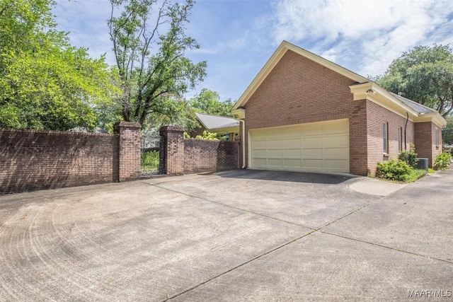 view of home's exterior with central AC and a garage