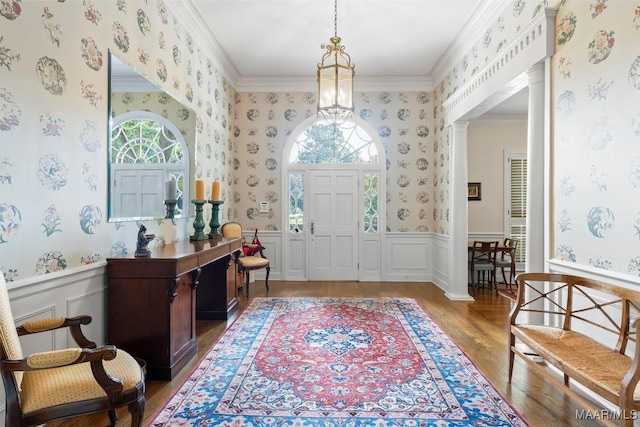 foyer with light wood-type flooring, plenty of natural light, and ornamental molding