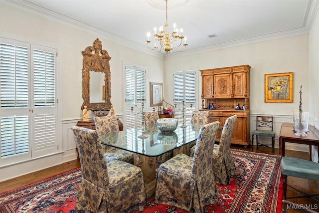 dining room featuring a notable chandelier, dark hardwood / wood-style flooring, and ornamental molding