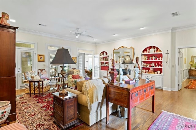 living room with ceiling fan, ornamental molding, and hardwood / wood-style flooring