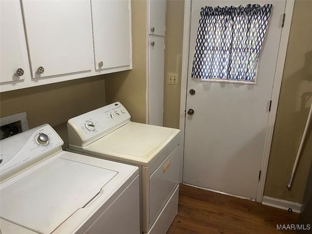 washroom with washing machine and clothes dryer, cabinets, and dark hardwood / wood-style floors