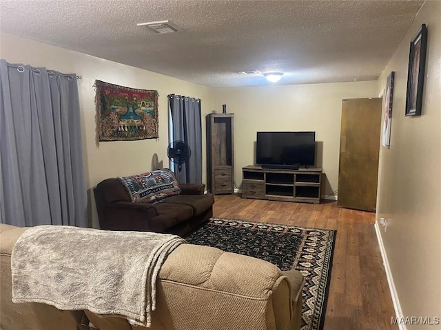 living room featuring hardwood / wood-style flooring and a textured ceiling