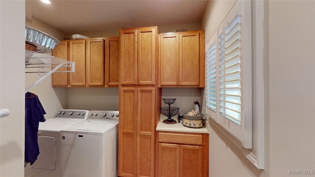 washroom with cabinets and separate washer and dryer