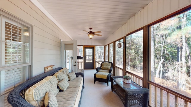 sunroom featuring ceiling fan