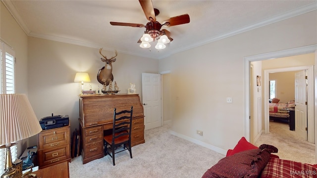 carpeted office space with ceiling fan and ornamental molding