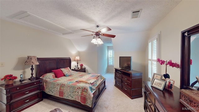 carpeted bedroom with ceiling fan, a textured ceiling, and vaulted ceiling