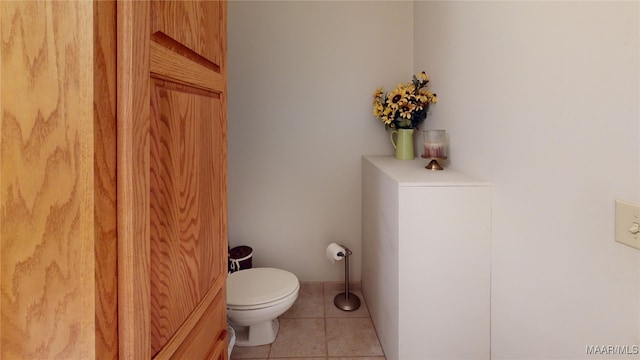 bathroom with toilet and tile patterned floors