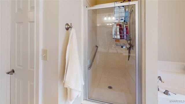 bathroom featuring a shower with shower door