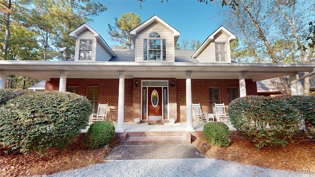 new england style home featuring a porch