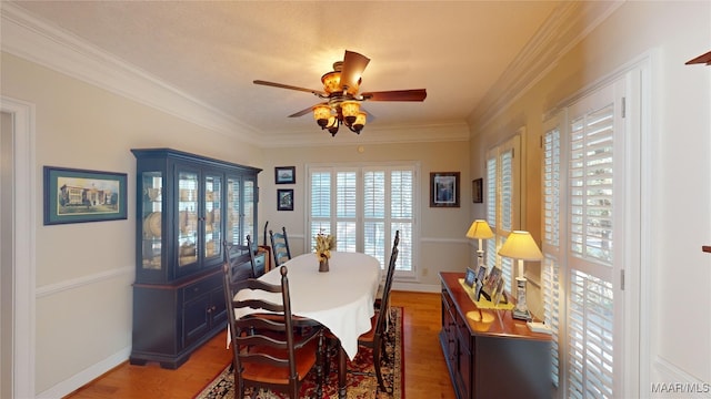 dining room with hardwood / wood-style floors, ceiling fan, and ornamental molding