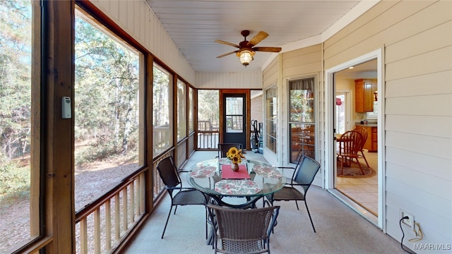 sunroom / solarium featuring ceiling fan