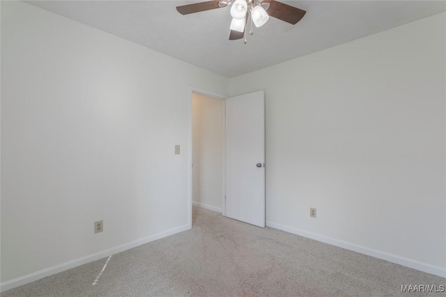 unfurnished room featuring ceiling fan and light carpet