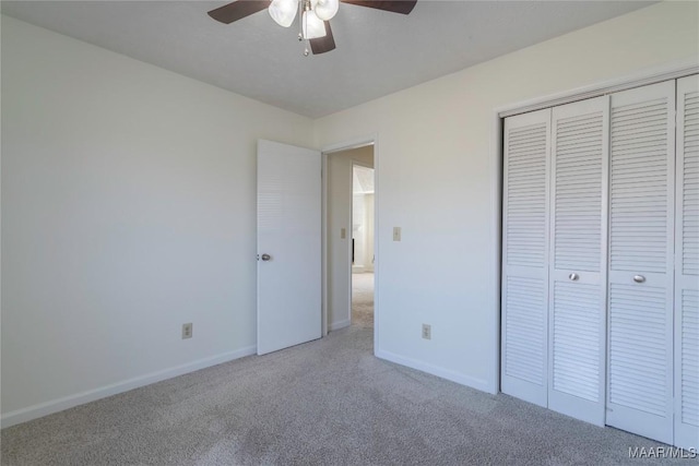 unfurnished bedroom with a closet, ceiling fan, and carpet flooring