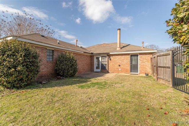 rear view of property with a patio area and a lawn