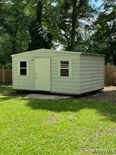 view of outbuilding featuring a yard