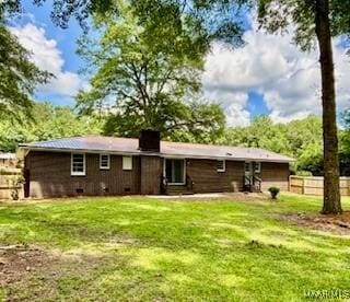 rear view of house with a yard