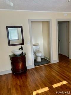 interior space with sink and dark wood-type flooring